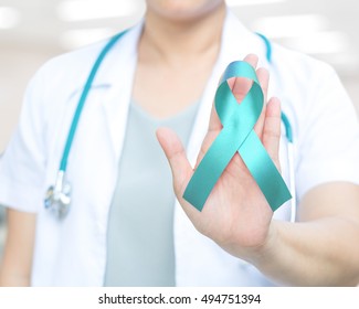 Female Doctor In White Uniform With Turquoise Green Ribbon Awareness In Hand For Addiction Recovery,Bone Tumor Awareness ,Congenital Diaphragmatic Hernia (CDH),Dysautonomia,Interstitial Cystitis