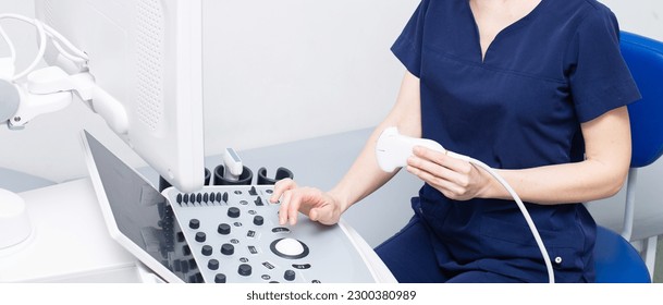 Female doctor woman in uniform sitting in office in a hospital with ultrasound diagnostic machine equipment and ready to examine patients and do ultrasound of heart, thyroid gland or abdominal cavity - Powered by Shutterstock