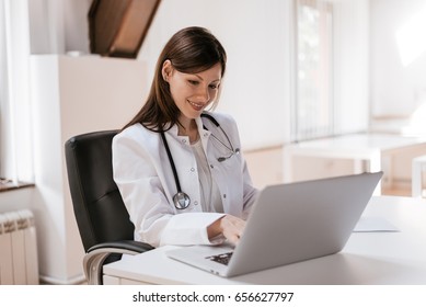 Female doctor at work using laptop