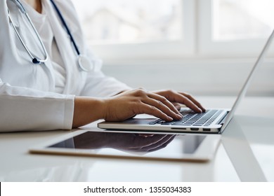 Female Doctor Working With Her Laptop In The Office