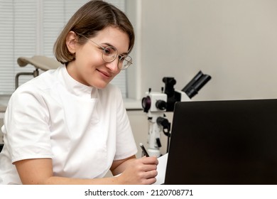 Female Doctor Working At Her Office Online Using Laptop. Telemedicine Concept. Primary Care Consultation Of The Patient By Video Call.Healthcare And Medicine Concept.