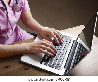 Female doctor working with laptop