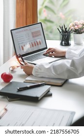 Female Doctor Working On Laptop Computer, Analyzing And Report Treatment Effect At Office, Medical Healthcare And Doctor Service Concept.