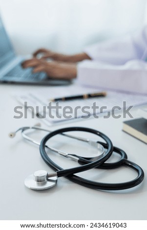 Female doctor works with her laptop computer in the doctor's office.