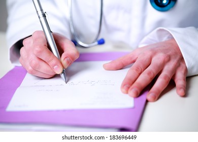 Female Doctor Writing A Prescription