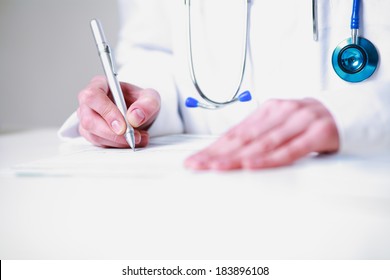 Female Doctor Writing A Prescription