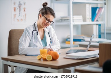 Female Doctor Writing Prescription In The Clinic