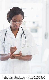 Female Doctor Writing Report In The Bright Hospital