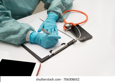 Female Doctor Writing Something Sitting At Her Office. Healthcare And Medical Concept.
