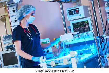 Female Doctors In Front Of Intensive Care Unit For Newborn Infant Baby