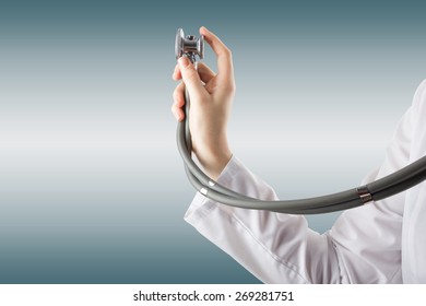 Female doctor's hand holding stethoscope on blurred background. Concept of Healthcare And Medicine. Copy space
