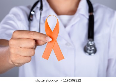 Female Doctor's Hand With Ribbon Showing Uterine Cancer Awareness - Powered by Shutterstock