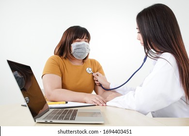 Female doctors use stethoscope to examine the heart of obese female patients. That is at risk for coronavirus infection. The concept of treatment to prevent severe pathogens