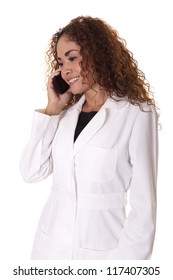 Female Dr. Smiles While Talking On The Phone, Isolated On A White Background.