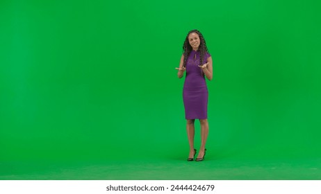 Female in dress isolated on chroma key green screen background. Full shot african american woman tv news host standing talking looking at camera. - Powered by Shutterstock