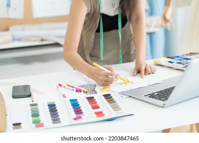 Female dressmaker or hands of fashion designer drawing sketches model on paper for clothes in atelier in tailor shop. Fashion, dressmaking concept - Powered by Shutterstock