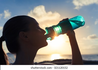 Female Drinking A Bottle Of Water