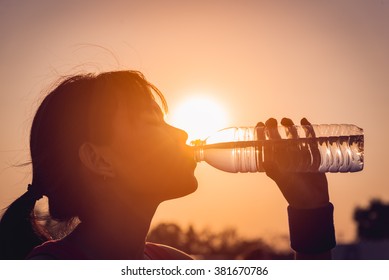 Female Drinking A Bottle Of Water Silhouette. 