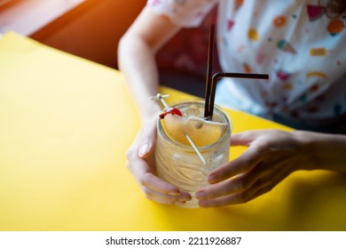 Female Drinking Kamikaze Cocktail Tiki Glass, Vodka, Triple Sec, Lemon, Cherry