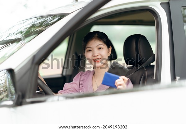 Female driver beginner\
sitting in a car