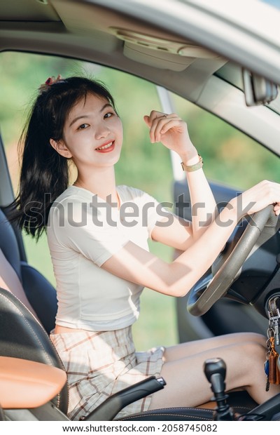 Female driver beginner\
sitting in a car