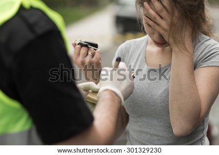 Image, Stock Photo A drunk woman is sitting at a table. Next to her is a bottle of alcohol and a glass. Bright yellow lights flicker in the background.