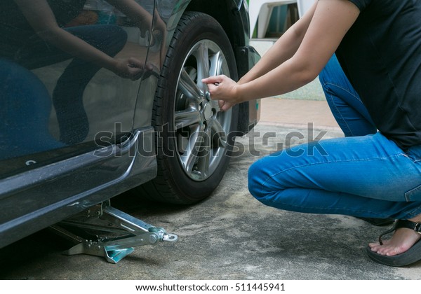 Female Driver Changing Tyre On Her Stock Photo Shutterstock