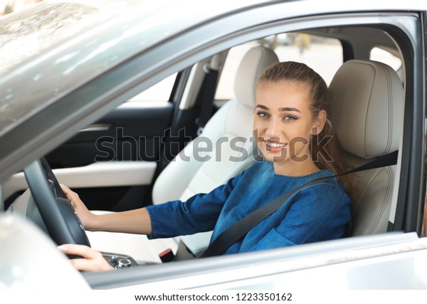Female driver
with fastened safety belt in
car