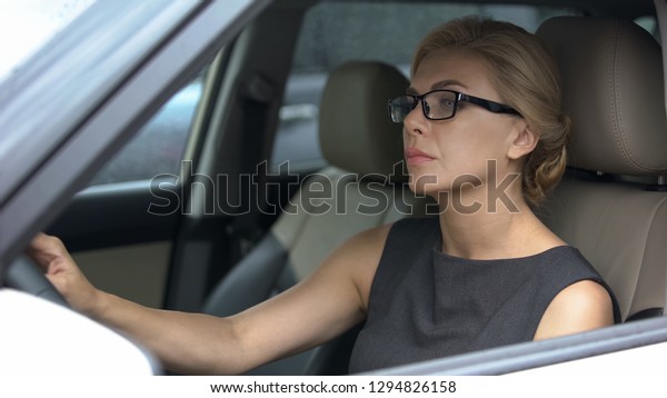 Female driver getting stuck in traffic jams,\
big city life, driving\
regulations