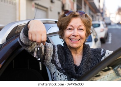 Female driver in golden age travelling with car