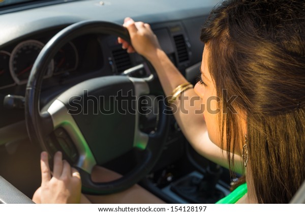 Female\
driver inside the car behing the steering\
wheel