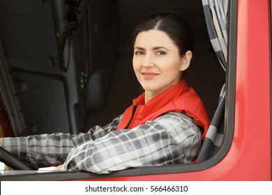 Female Driver Looking Out Of Truck Window