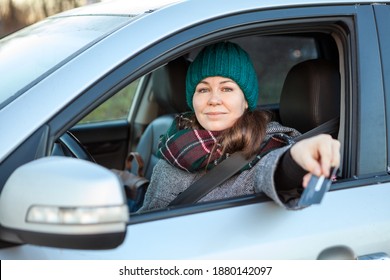 Female Driver Making Cashless Payment Via Credit Card Inside Of Her Car, Stretching Hand Through The Window