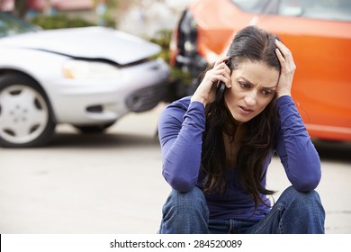 Female Driver Making Phone Call After Traffic Accident