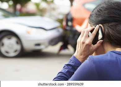 Female Driver Making Phone Call After Traffic Accident