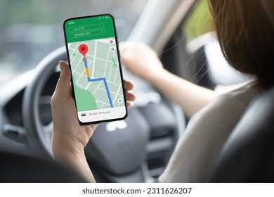 
female driver Use your smartphone to view a map showing your travel route. and use the app to go to the destination transport concept - Powered by Shutterstock