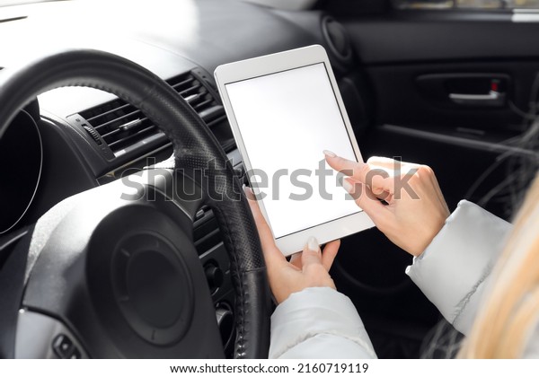 Female driver using tablet computer for\
navigation, closeup