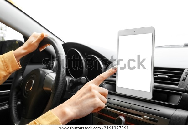 Female driver\
using tablet computer for\
navigation
