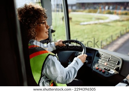 Female driver waiting for passengers to board the bus.
