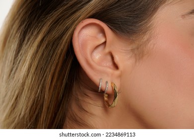 Female ear with three earrings. Close up, macro - Powered by Shutterstock