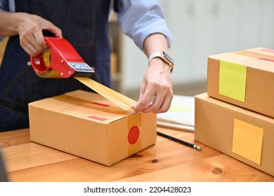 A Female E-commerce Business Startup Or Worker Packing Her Shipping Box, Preparing Shipping Orders In Stock Room. Small Online Business Concept