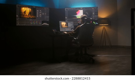 Female editor works in studio on computer using color grading control panel and professional video editing software. Color correction for film post production. Big screens with RGB graphic and levels. - Shutterstock ID 2288812415