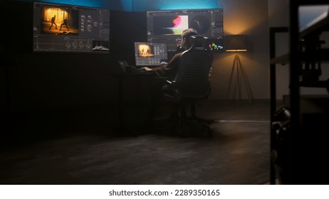 Female editor works in studio on computer using color grading control panel and professional video editing software. Color correction for film post production. Big screens with RGB graphic and levels. - Shutterstock ID 2289350165