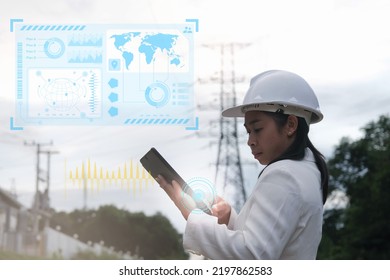 Female Electrical Engineer Working On Tablet With Virtual Icon Diagram Near High Voltage Pole, Inspecting Power Grid. Wind Turbine Engineer For Electric Power Generation. Renewable Energy Concept