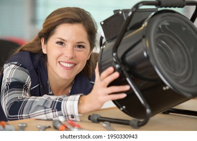 Female Electrician Working On Appliance