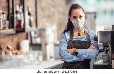 Female Employee In A Cafe Stands Unhappy With Arms Crossed Wearing Face Mask.