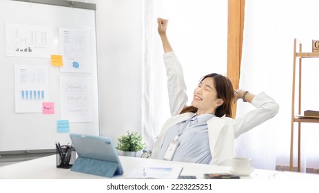 Female employee is doing a relaxing posture after a hard Midday's work, Happy women resting at work after work is finished, Fatigue is eased, Relax, Attractive, Stretch oneself, Stretch out the arms.  - Powered by Shutterstock