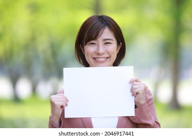 Female Employee With A Message Board 