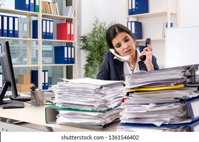 Female employee with too much work in the office 
