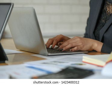 Female employees are using a laptop on the desk in the office.For business concept. - Powered by Shutterstock